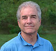 A male Your One Degree coach in a sky blue polo shirt.