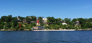 A view across Grand Lake of homes sitting high above the shoreline.