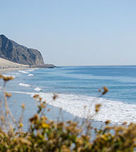 Long view of the Pacific ocean looking down the shoreline.
